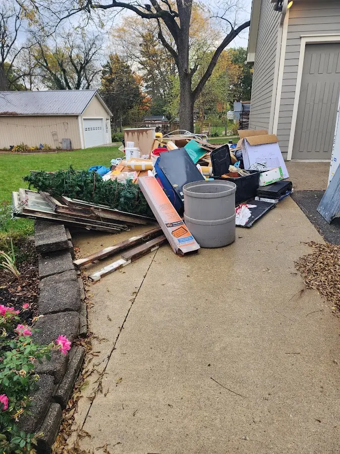 Dumpster being loaded with debris for Estate Cleanout Dumpster Rental in Rainbow Lakes Estates